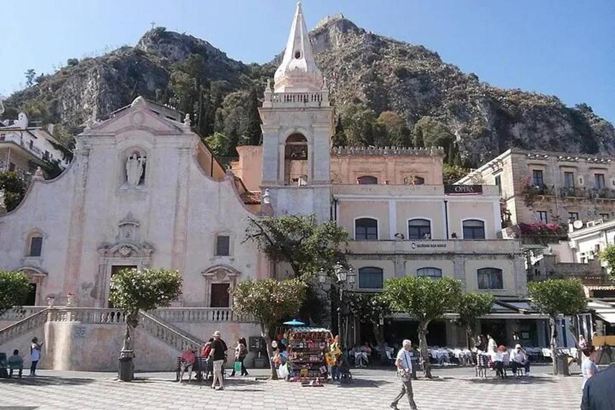 an old building with a mountain in the background