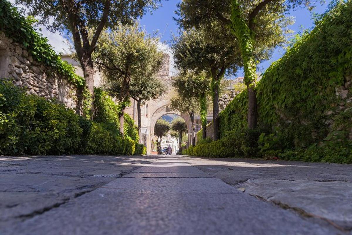 uma rua vazia com um arco ao longe