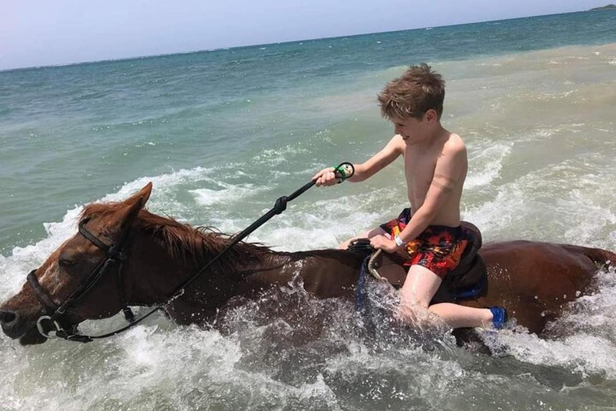 un ragazzo a cavallo nell'oceano