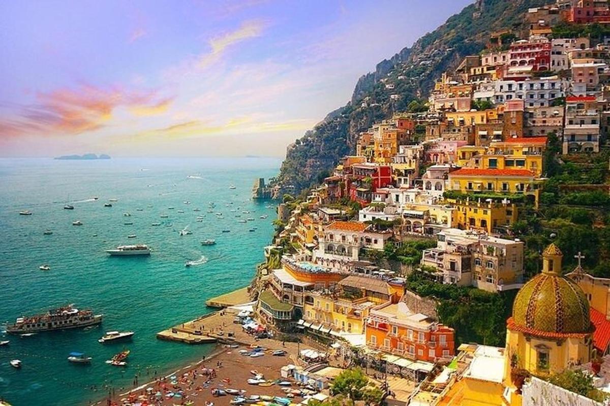 a group of buildings on a hill next to the ocean