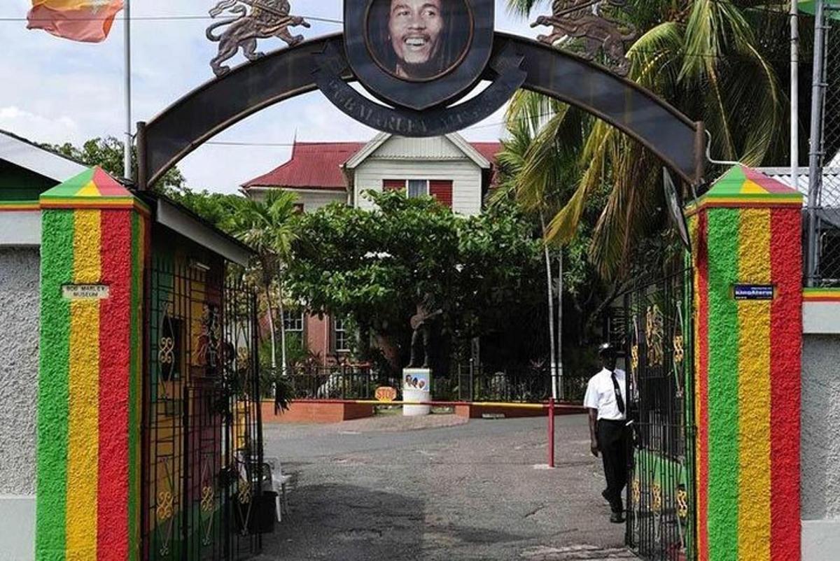 a man walking past a colorful gate with a picture on it