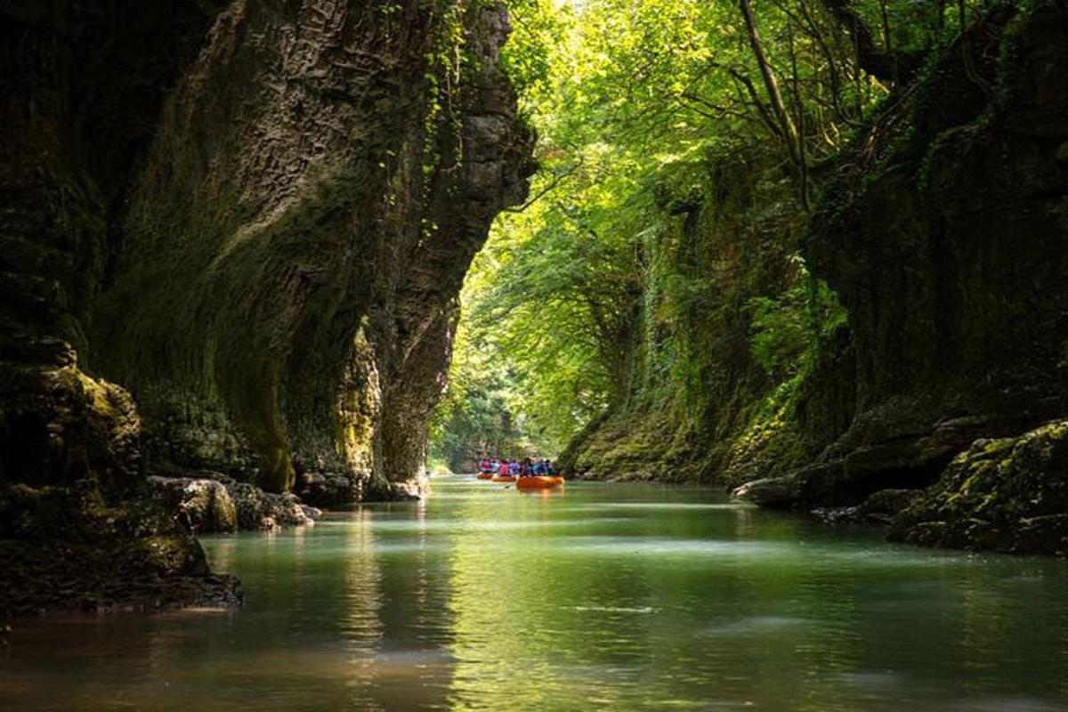 a group of people kayaking down a river in a cave