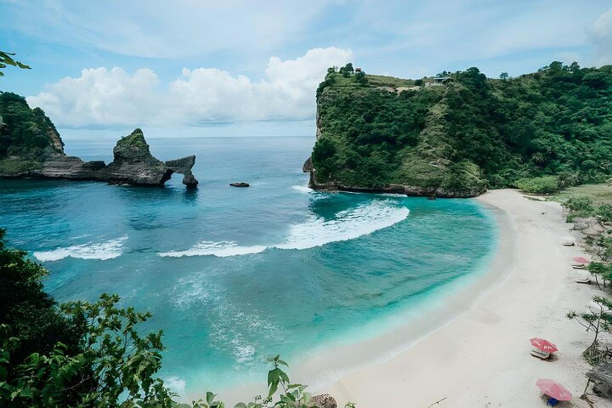 an aerial view of a beach with rocks and the ocean