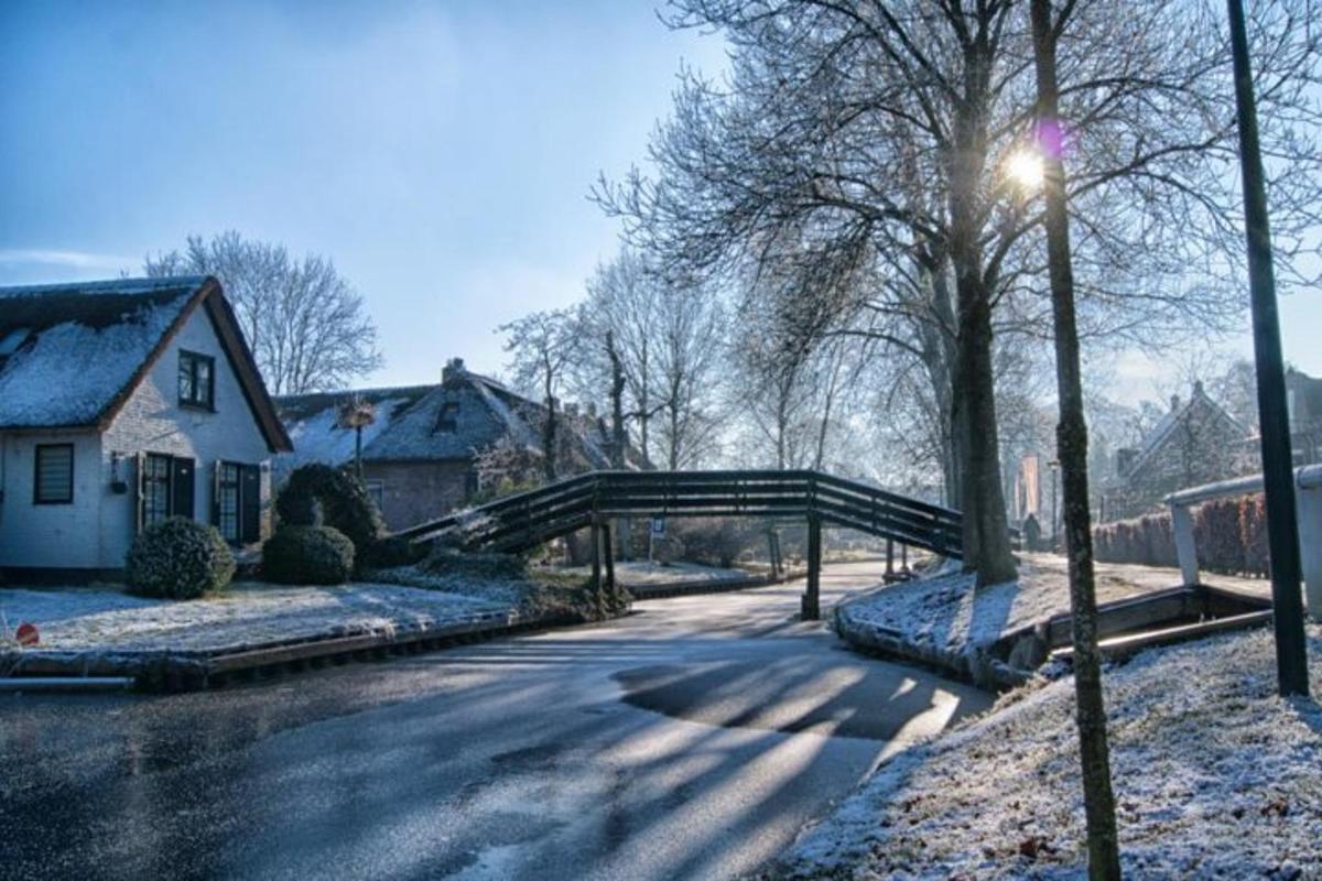 a bridge over a road with snow on the ground