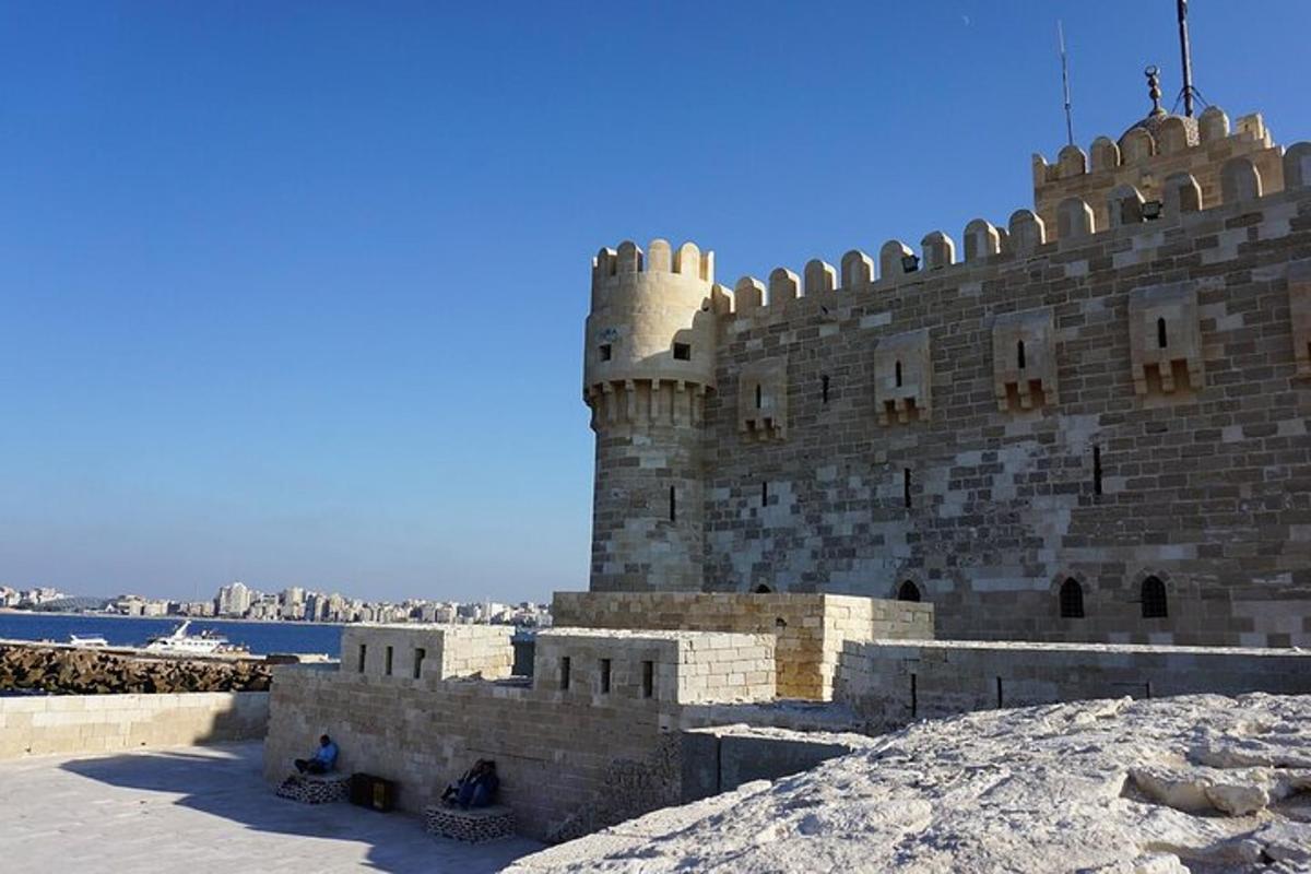 a castle in the snow next to the water