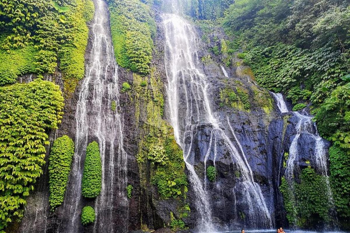 a group of waterfalls on the side of a mountain