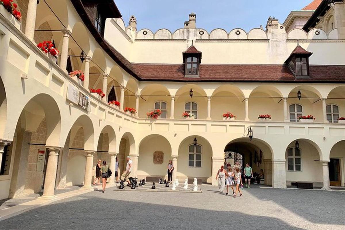 un grup de oameni care se plimbă în curtea unei clădiri