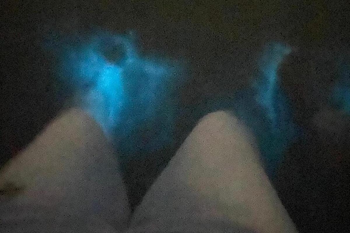 le gambe di una persona con luci blu nell'oscurità