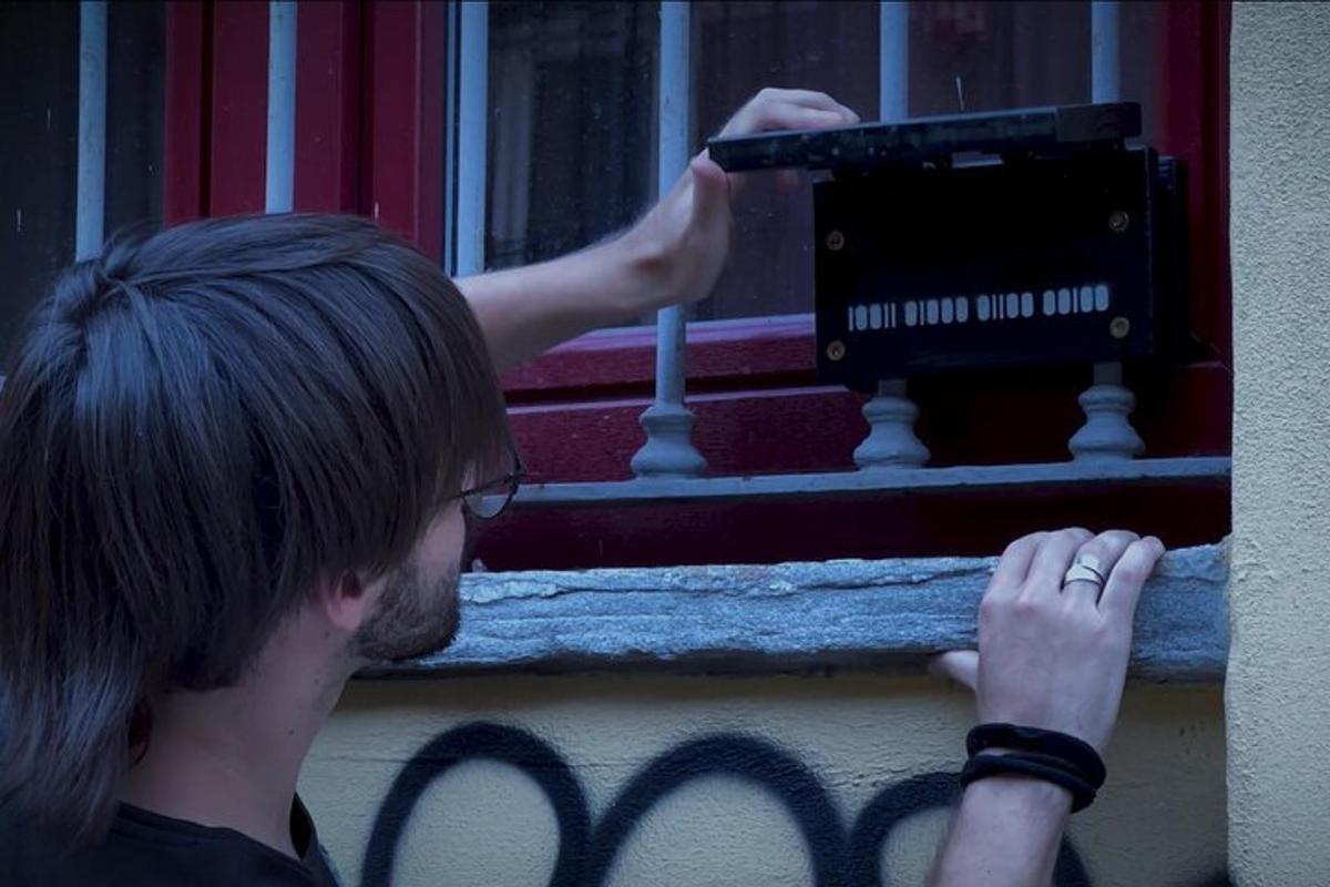a man is looking out of a window