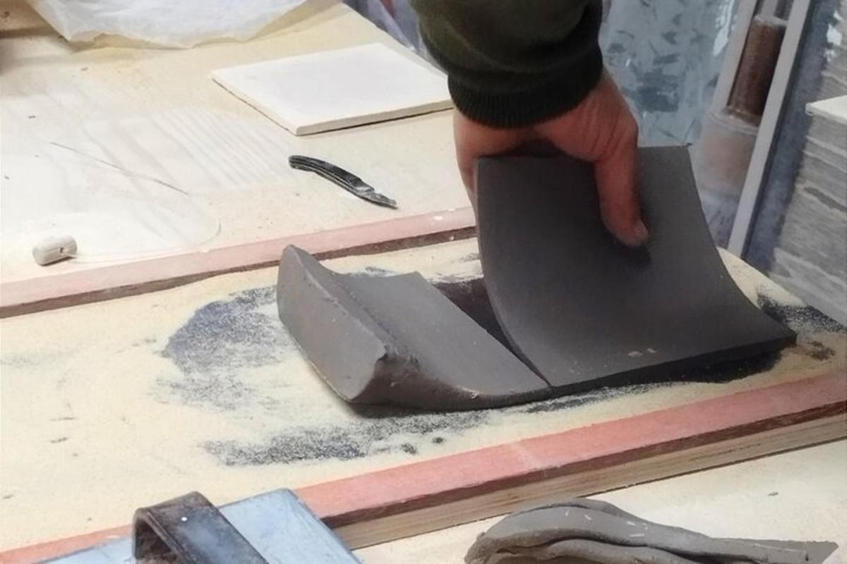 una persona cortando un trozo de madera con una herramienta
