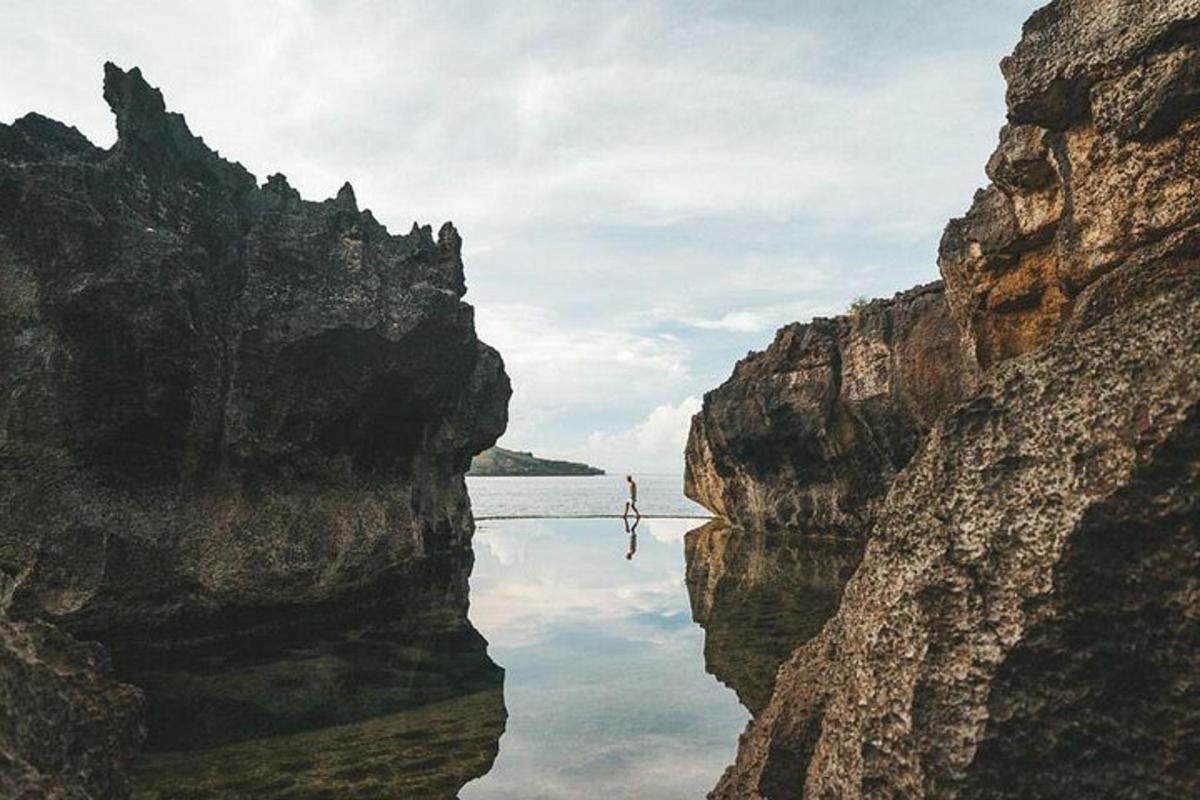 a body of water between two large rocky cliffs