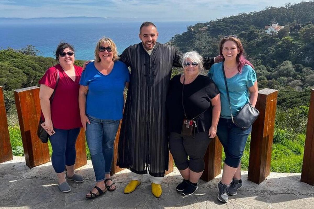 a group of people posing for a picture on a mountain