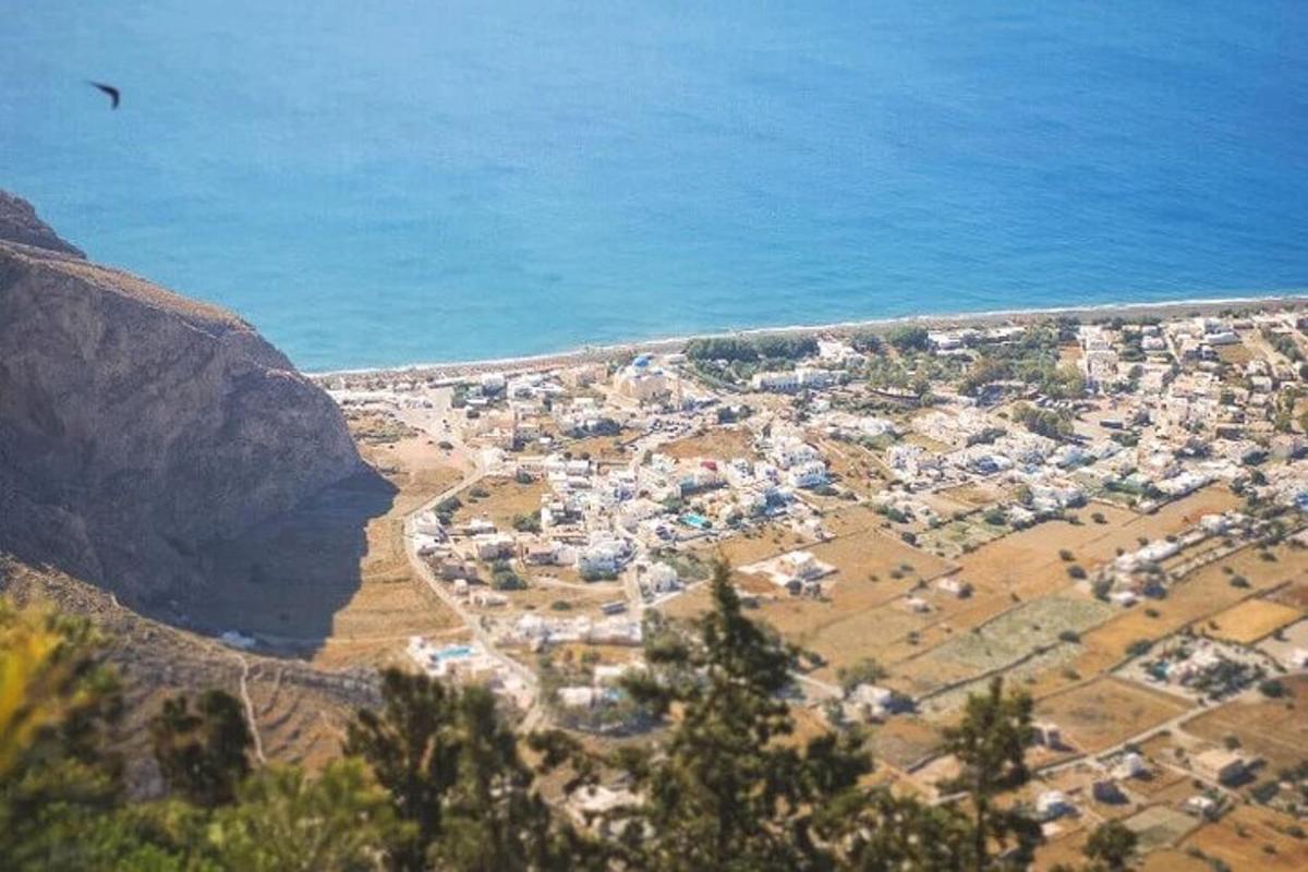 an aerial view of a town next to the ocean