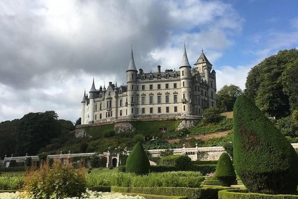 a castle on top of a hill with a garden