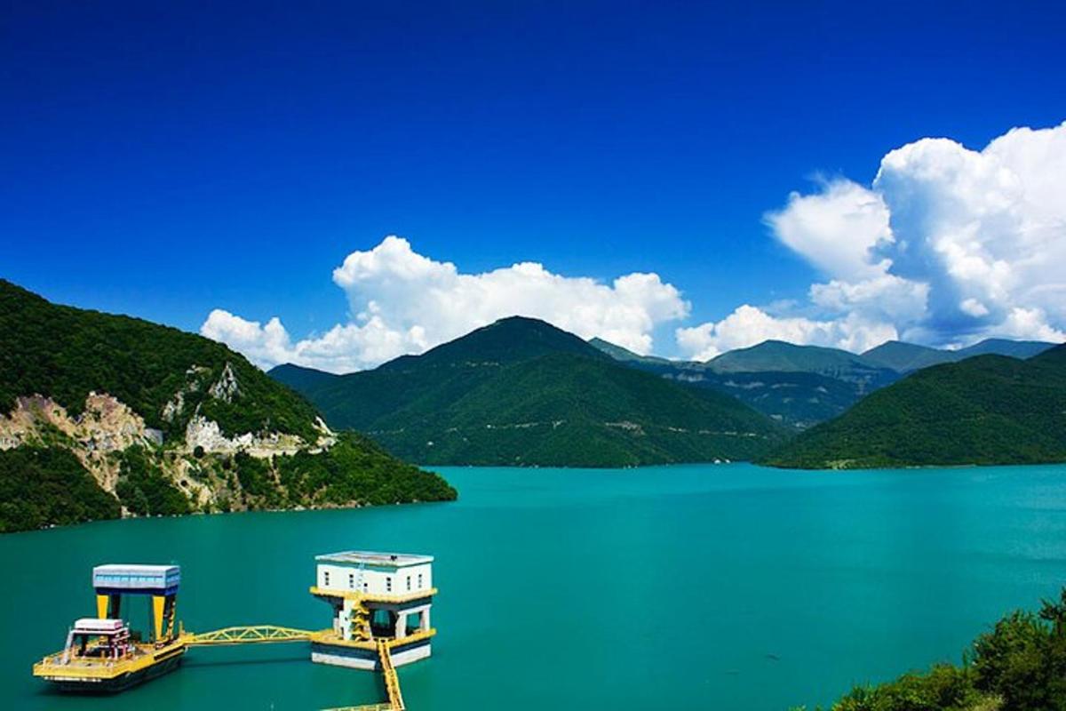 un vaixell en una gran massa d'aigua amb muntanyes