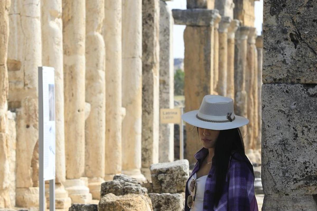 a woman wearing a hat standing in front of a building