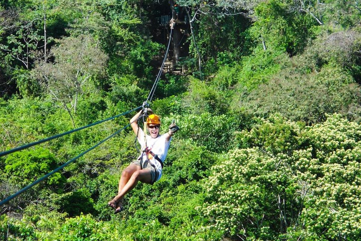 a woman on a zip line in the jungle
