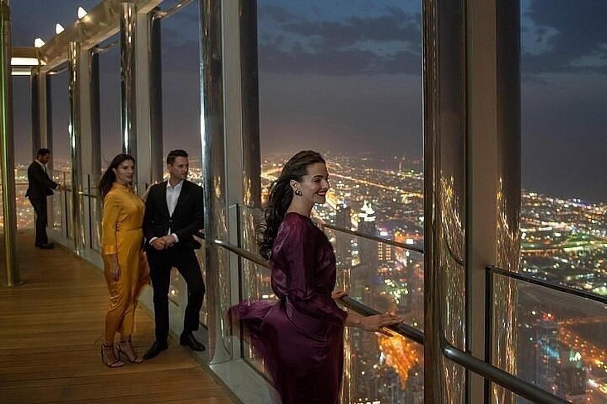 a group of people standing on top of a building