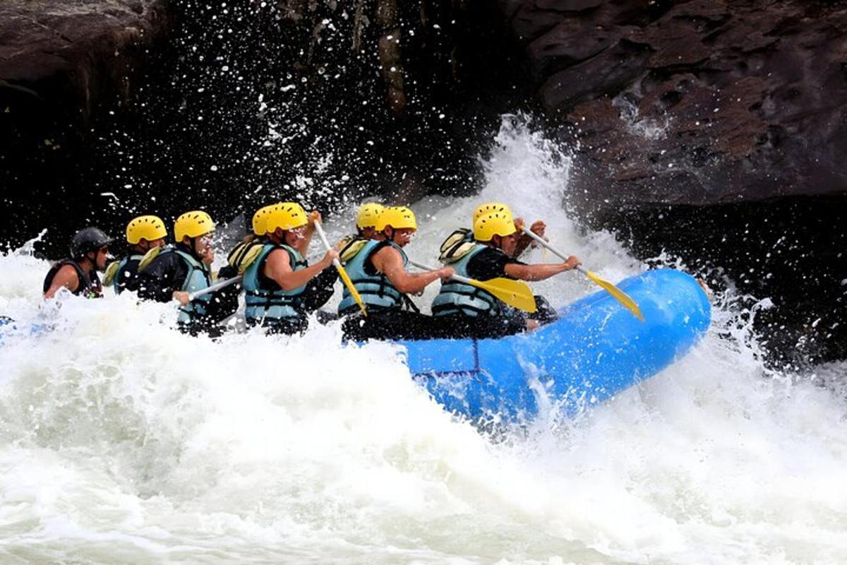 a group of people in a raft in a river