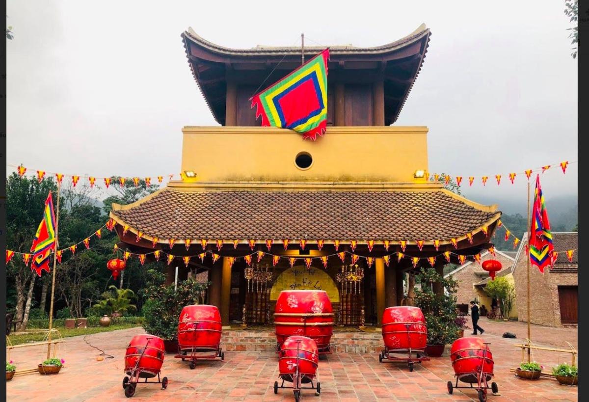 a pagoda with red chairs and a building with flags