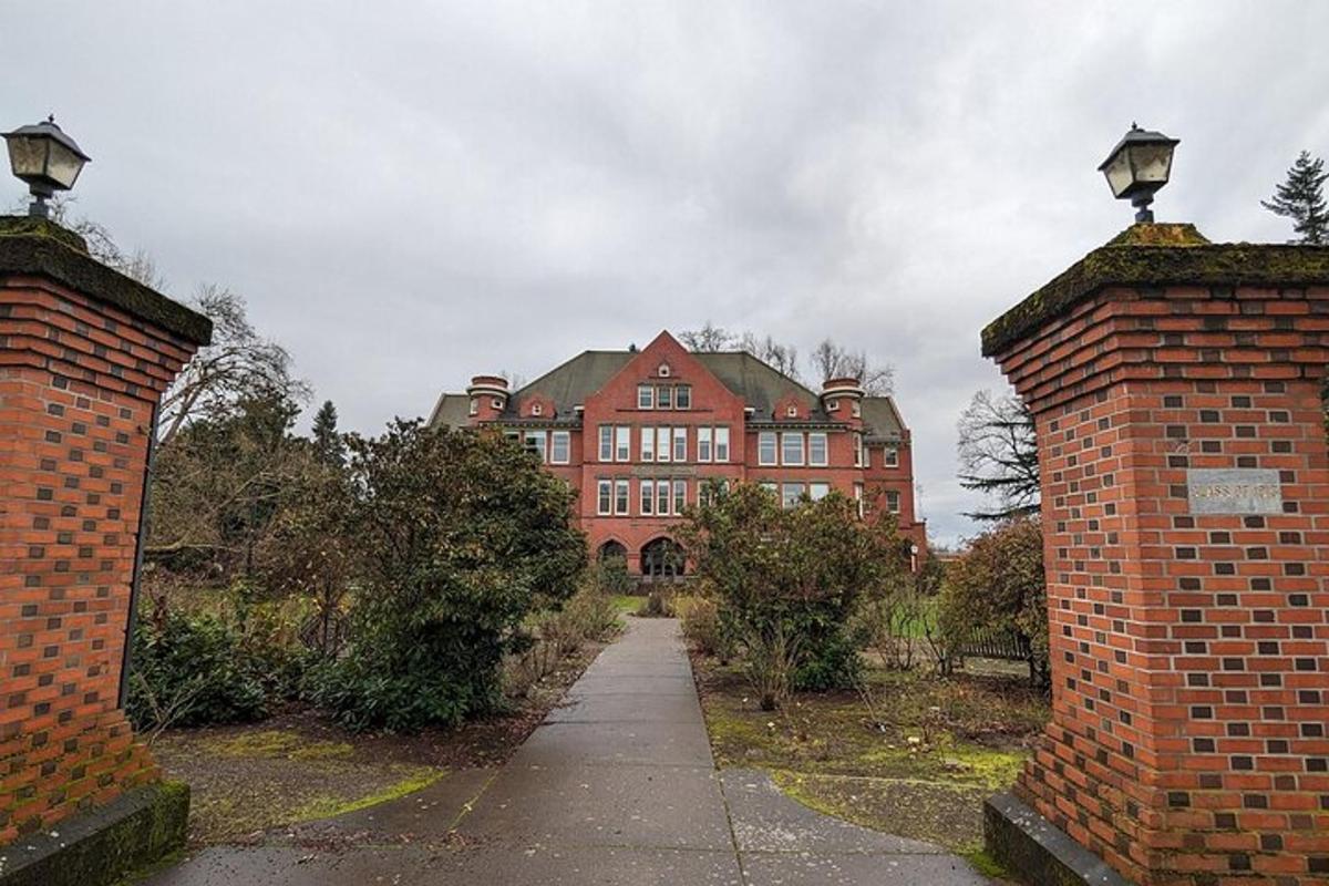 a large red brick building with a pathway in front
