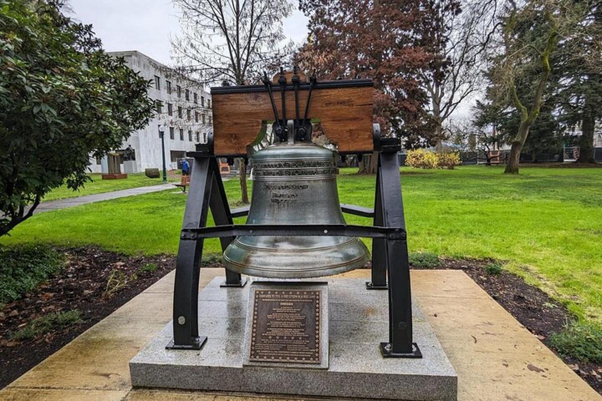 a large bell on display in a park