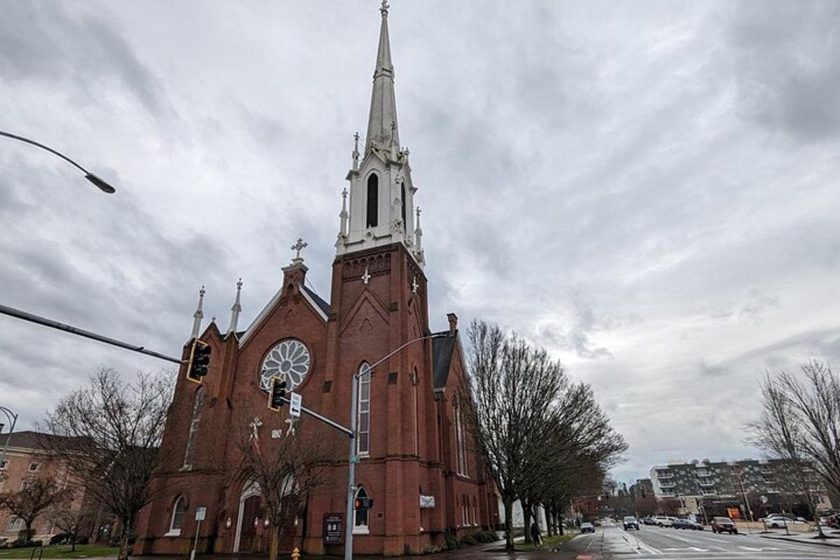 a large brick church with a steeple on a street