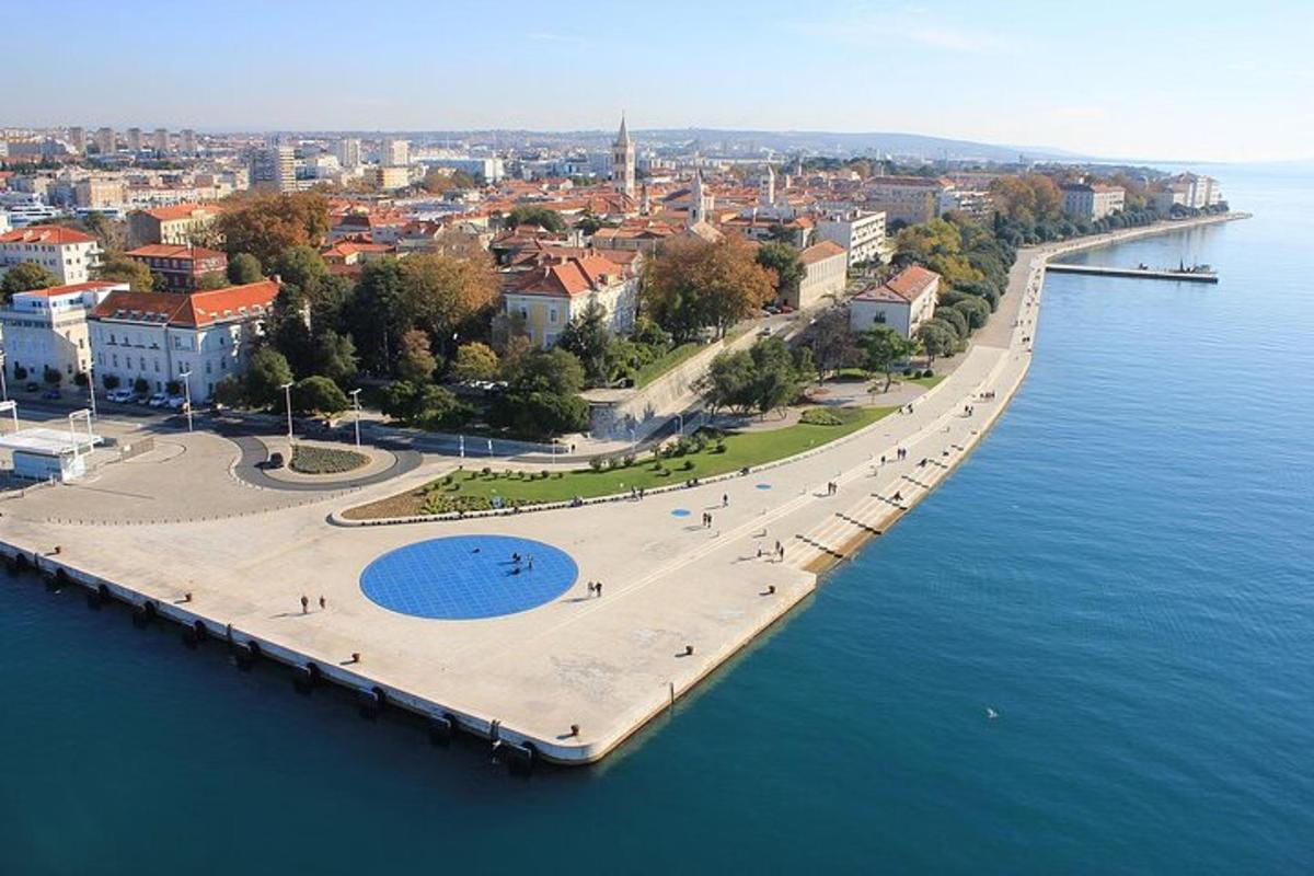 an aerial view of a city next to the water