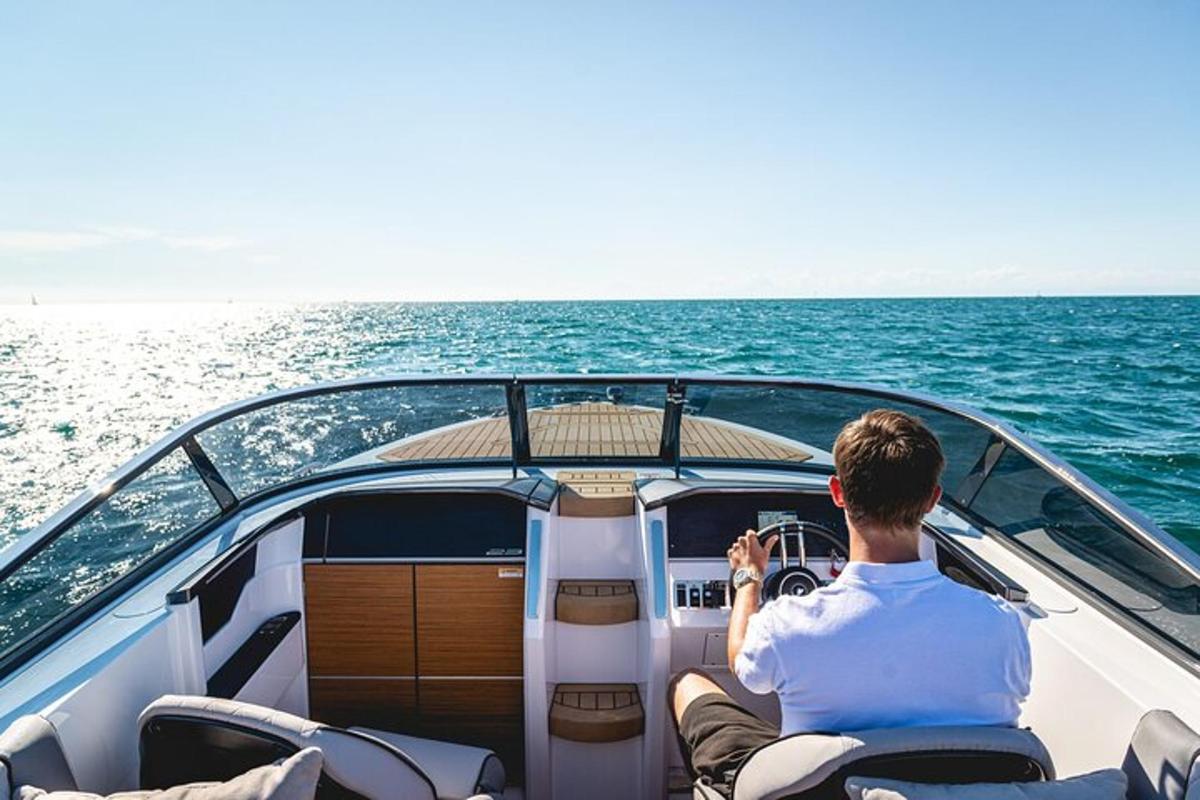 a man sitting on a boat in the ocean