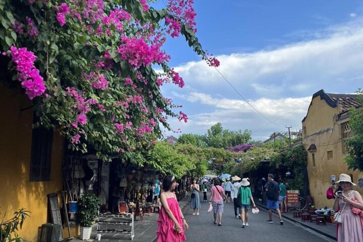 un gruppo di persone che camminano lungo una strada con i fiori