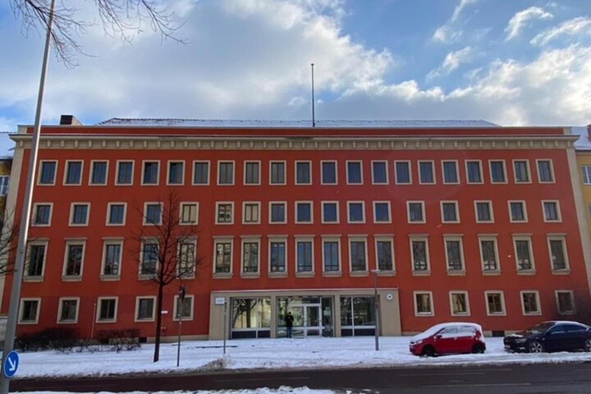 een rood gebouw met auto's ervoor geparkeerd