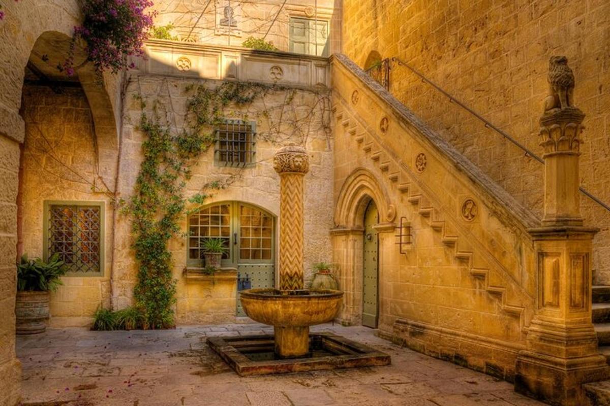 a stone building with a fountain in a courtyard