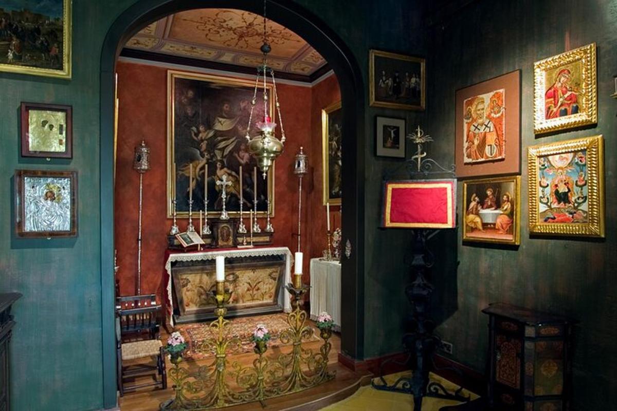a living room with a fireplace and paintings on the walls