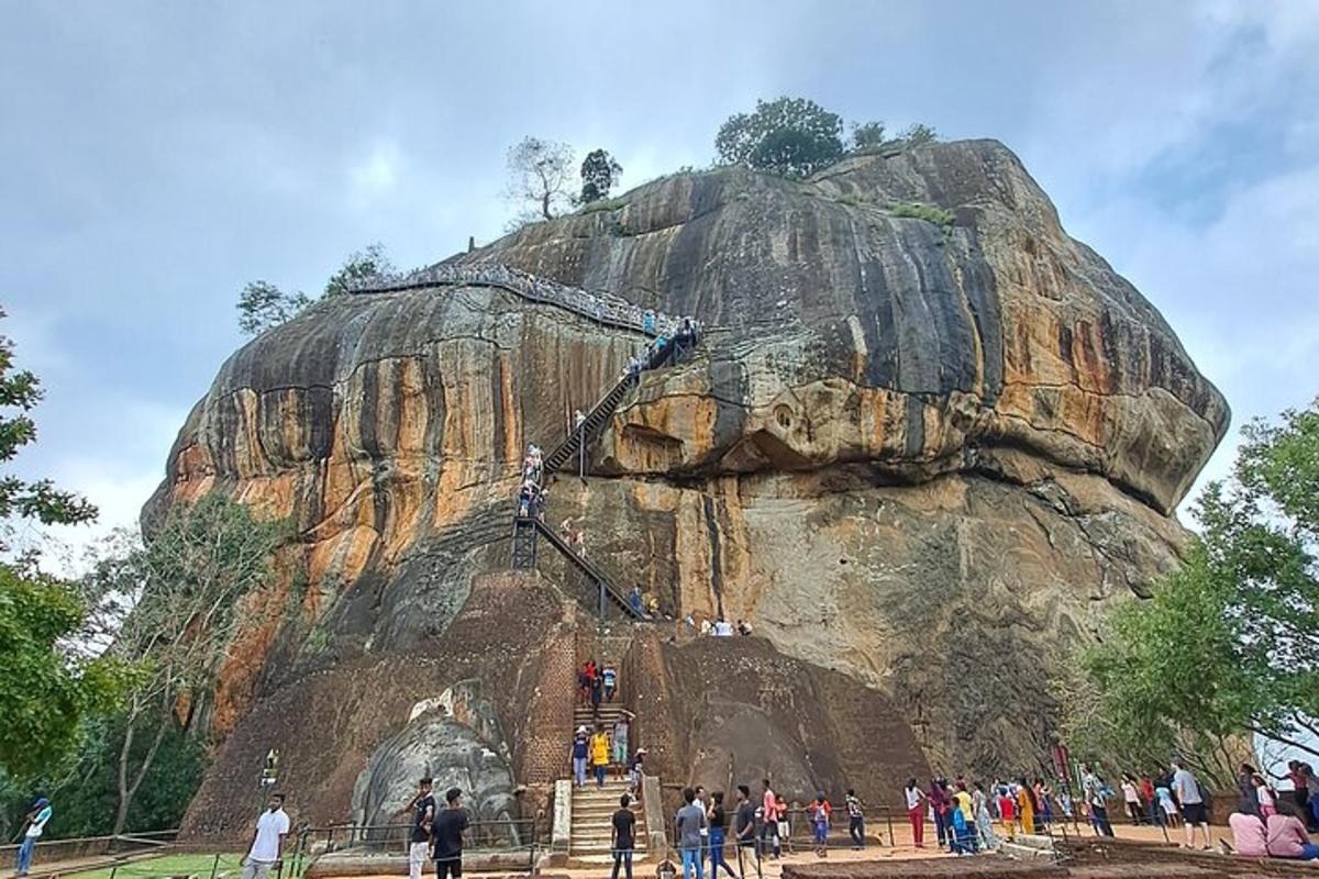 a group of people standing in front of a rock formation