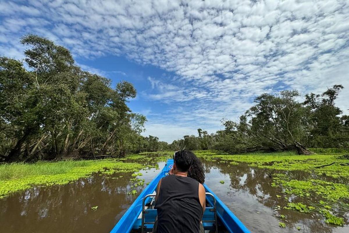 a woman riding a boat down a river