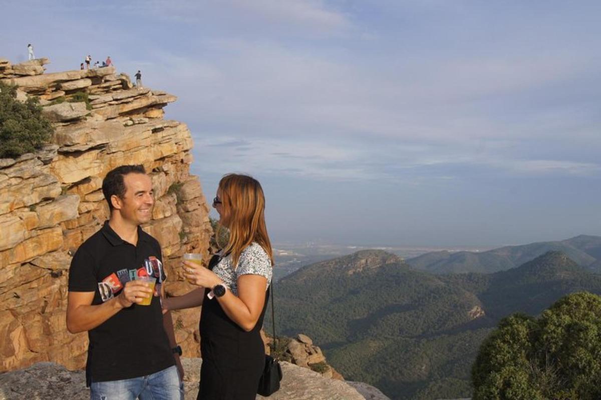 a man and a woman standing on top of a mountain