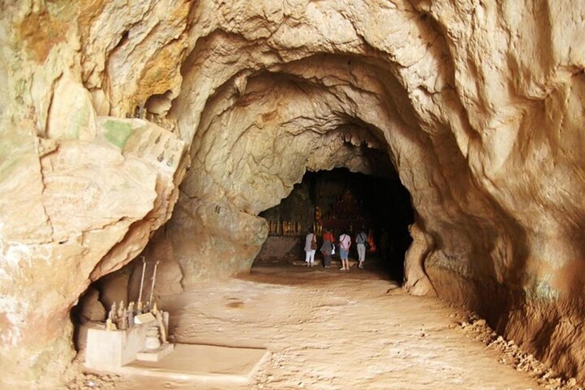 a group of people walking into a cave