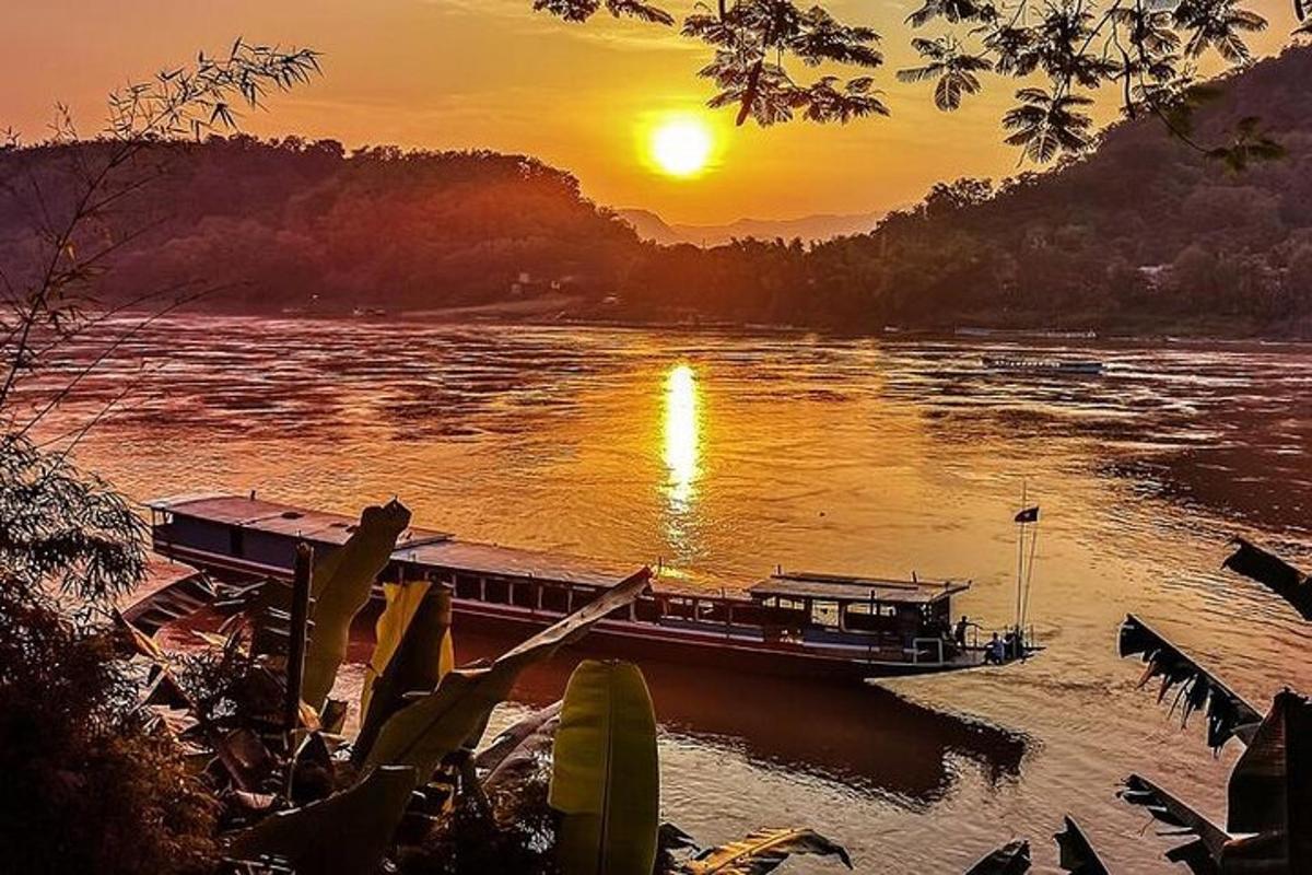 a boat on a river at sunset