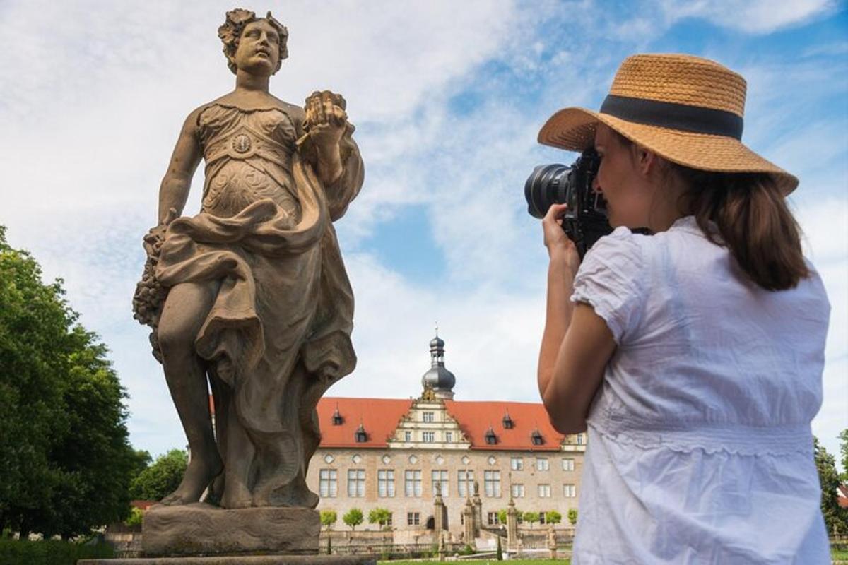 a woman taking a picture of a statue