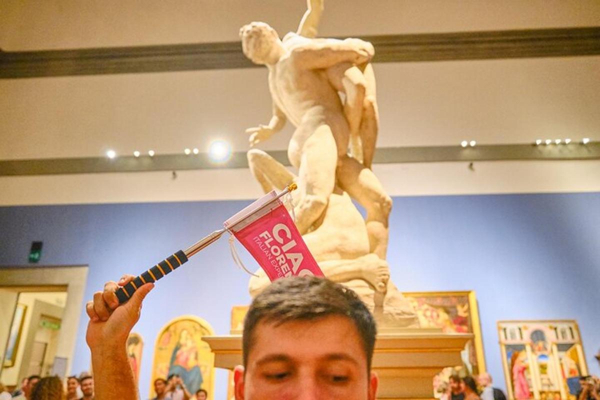 a man holding up a sign in front of a statue