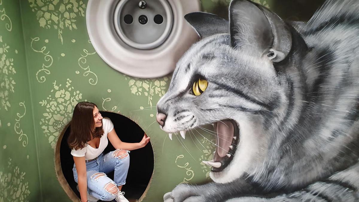 a woman in a room with a painting of a cat