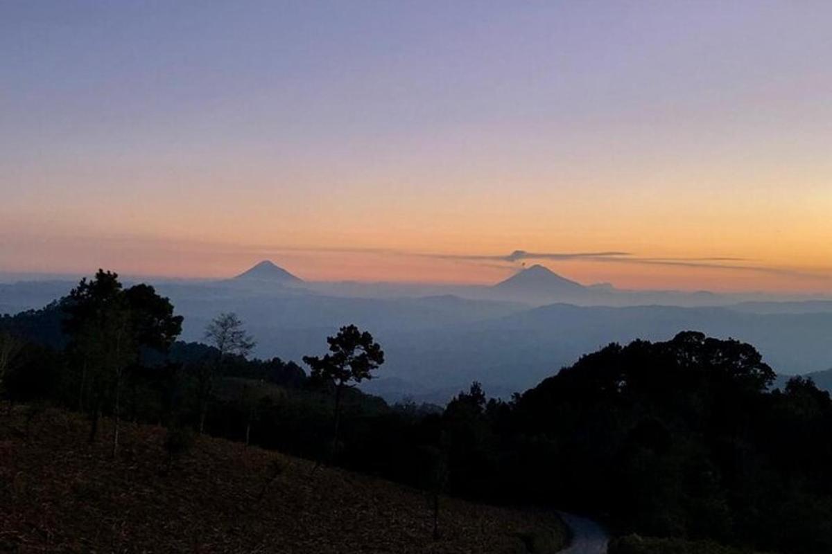 a view of the mountains at sunset with a road
