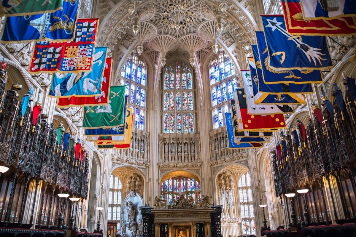 a large cathedral with flags and stained glass windows