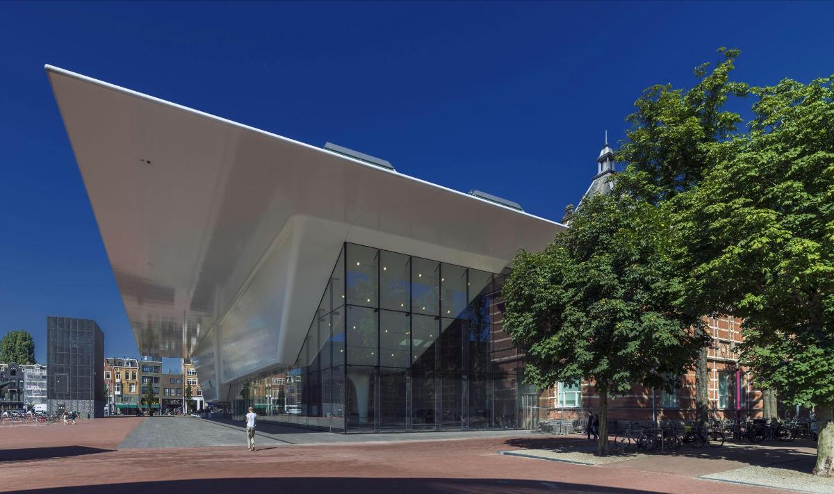 a large glass building with a curved roof