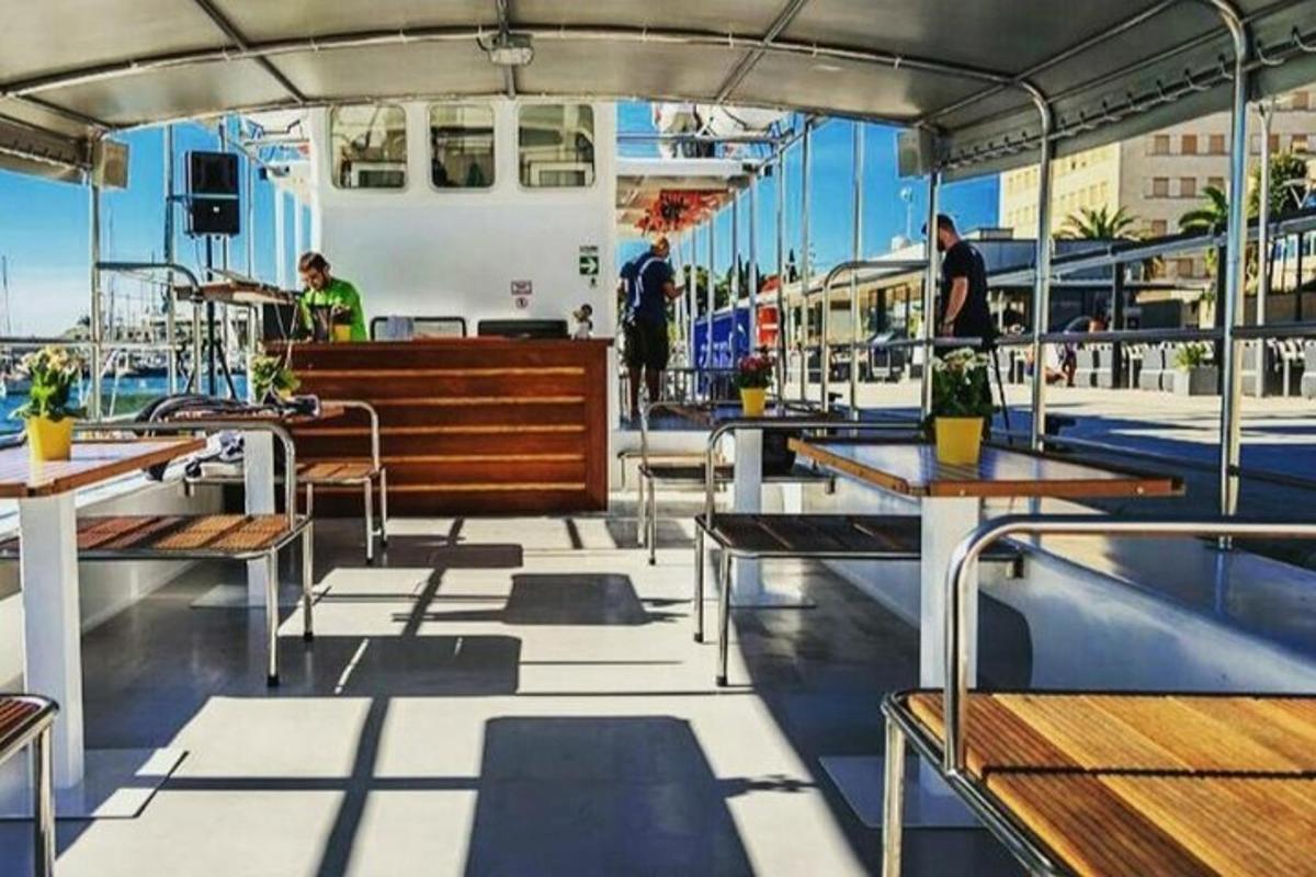 a deck of a boat with tables and benches