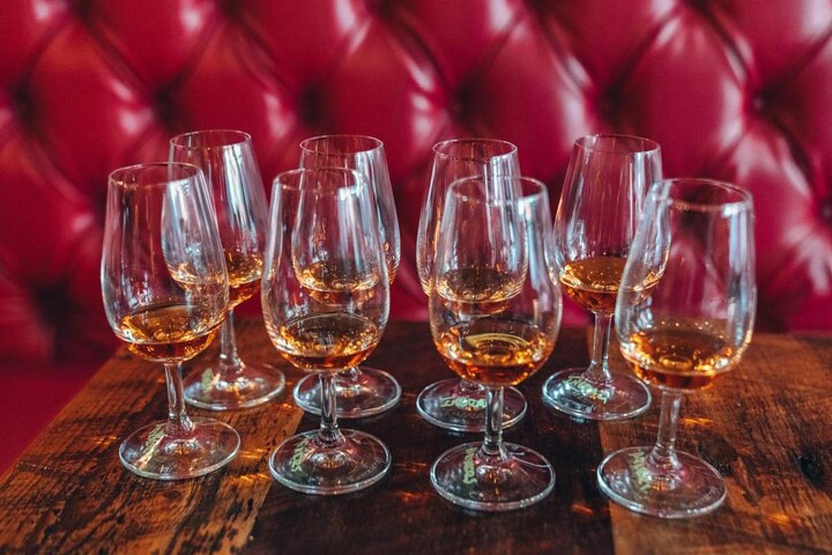 a group of wine glasses sitting on a wooden table