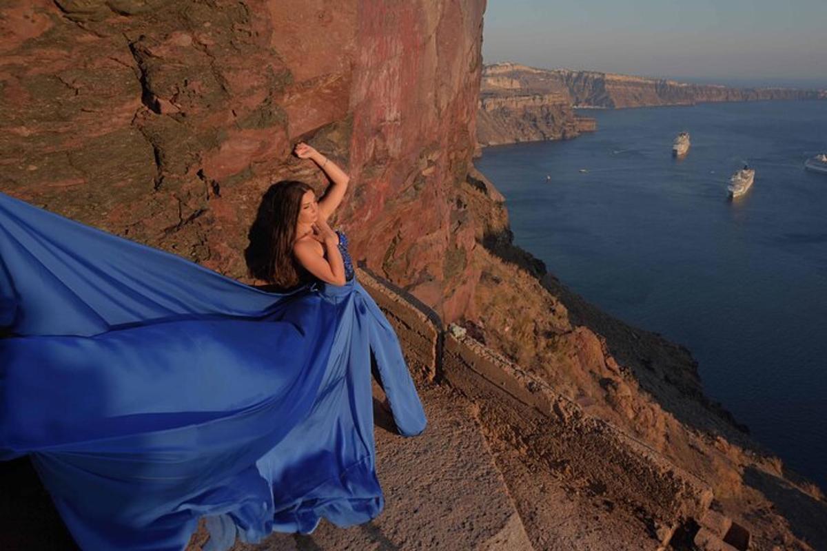 a woman sitting on a cliff with a blue flag