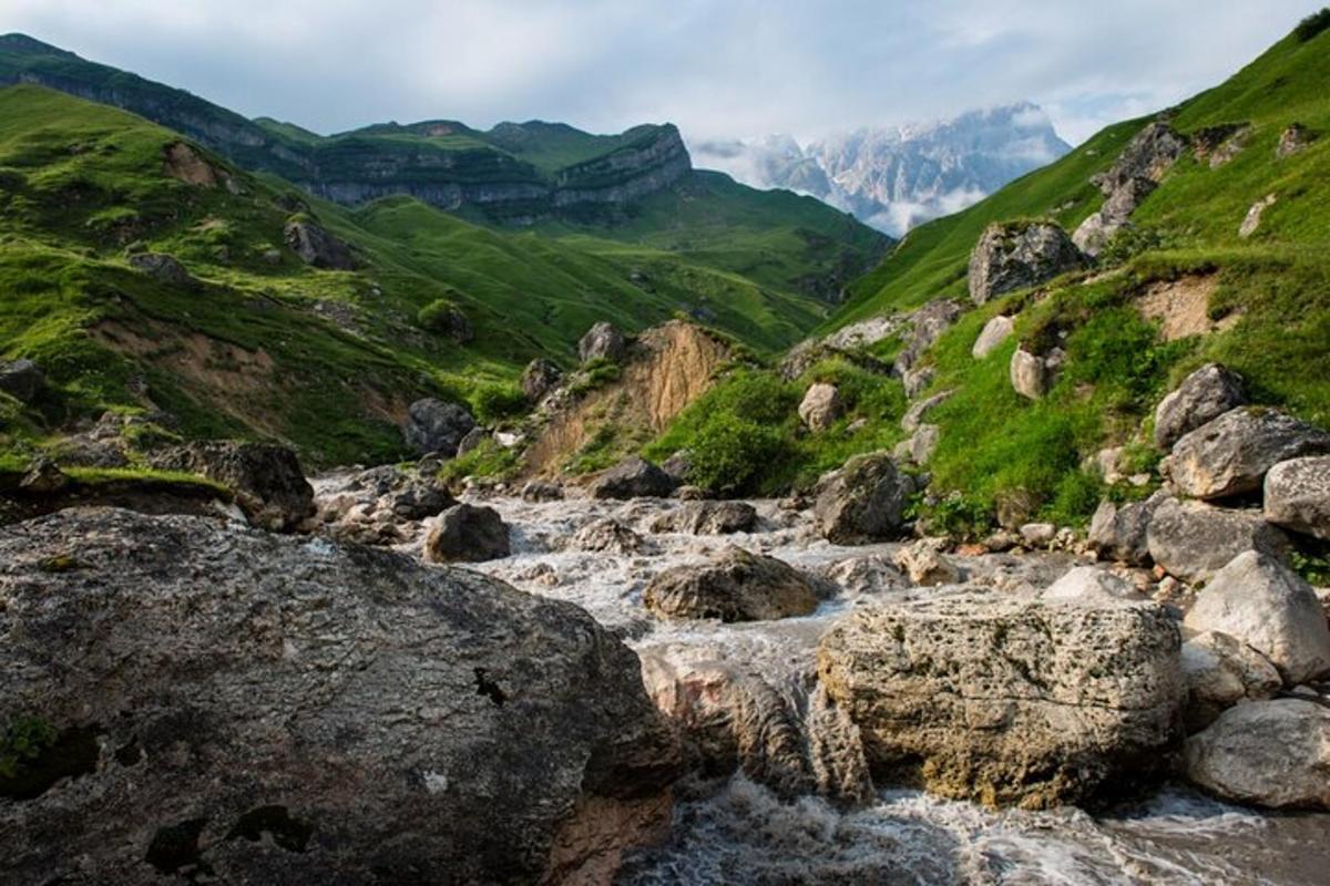 a mountain river with rocks in a valley