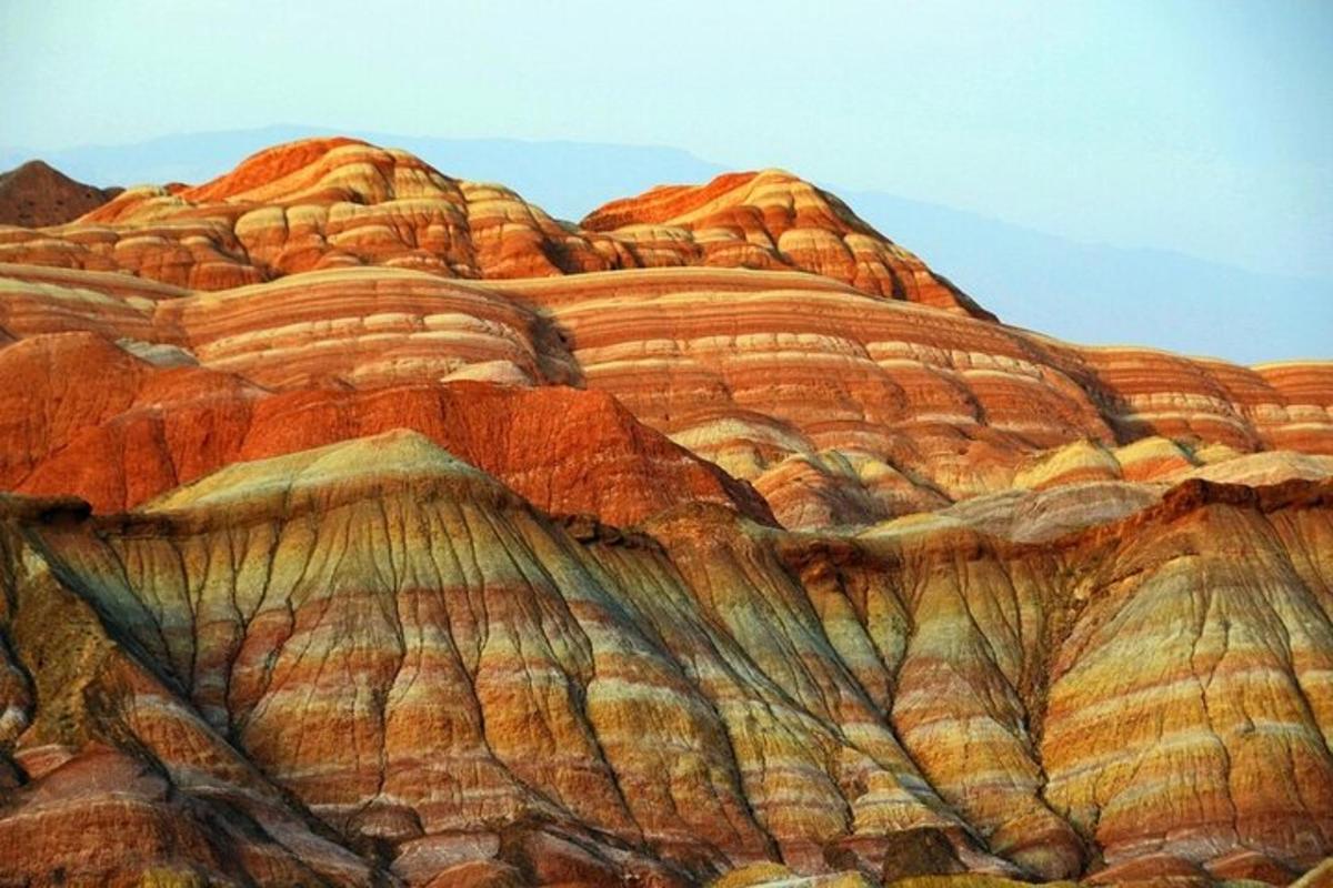a painting of a desert hillside with orange and brown