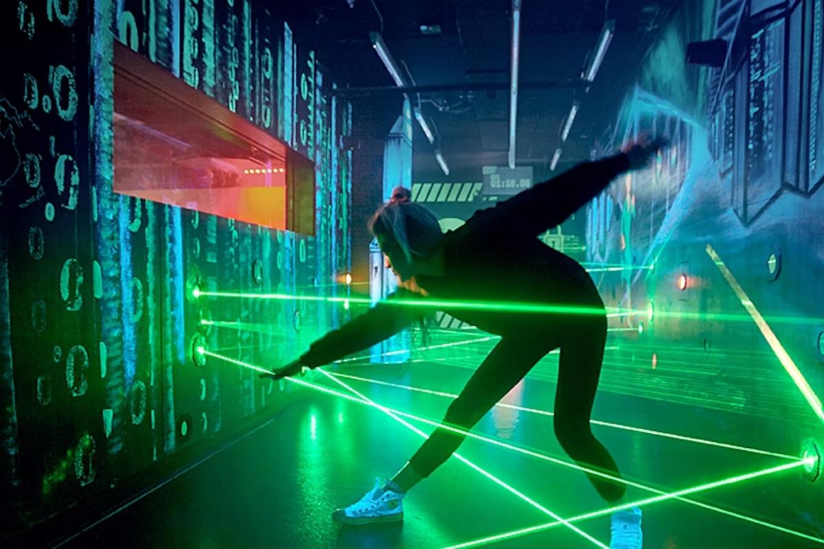 a man is dancing in a room with green lights